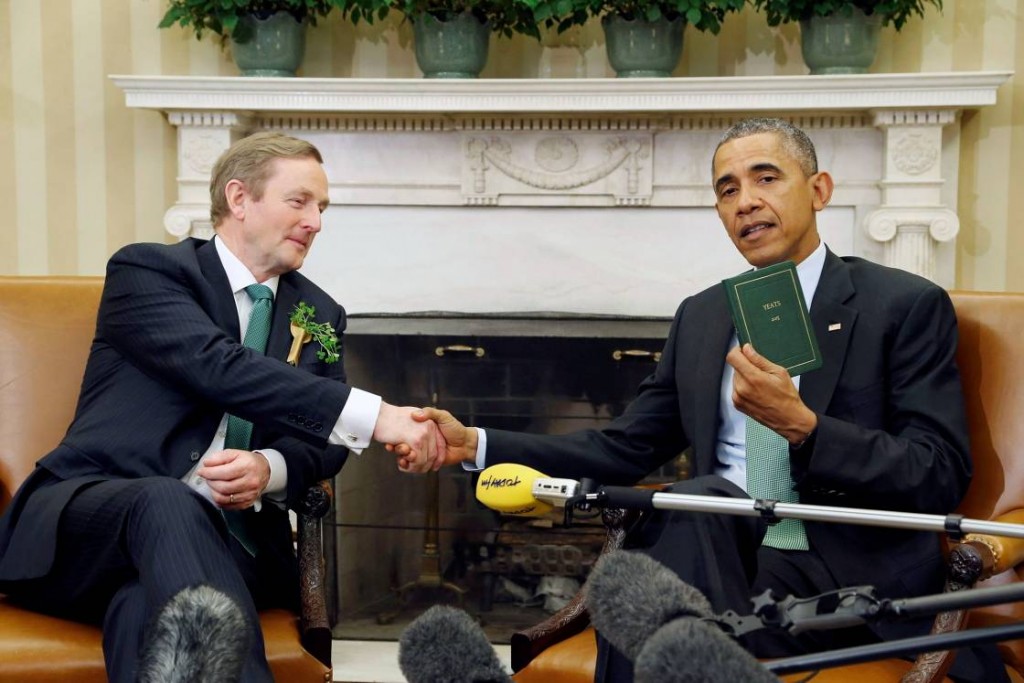 U.S. President Barack Obama holds a book of poetry by William Butler Yeats given to him by Ireland's Prime Minister Enda Kenny (L) during their meeting in the Oval Office as part of a St. Patricks Day visit at the White House in Washington March 17 2015. REUTERS/Jonathan Ernst